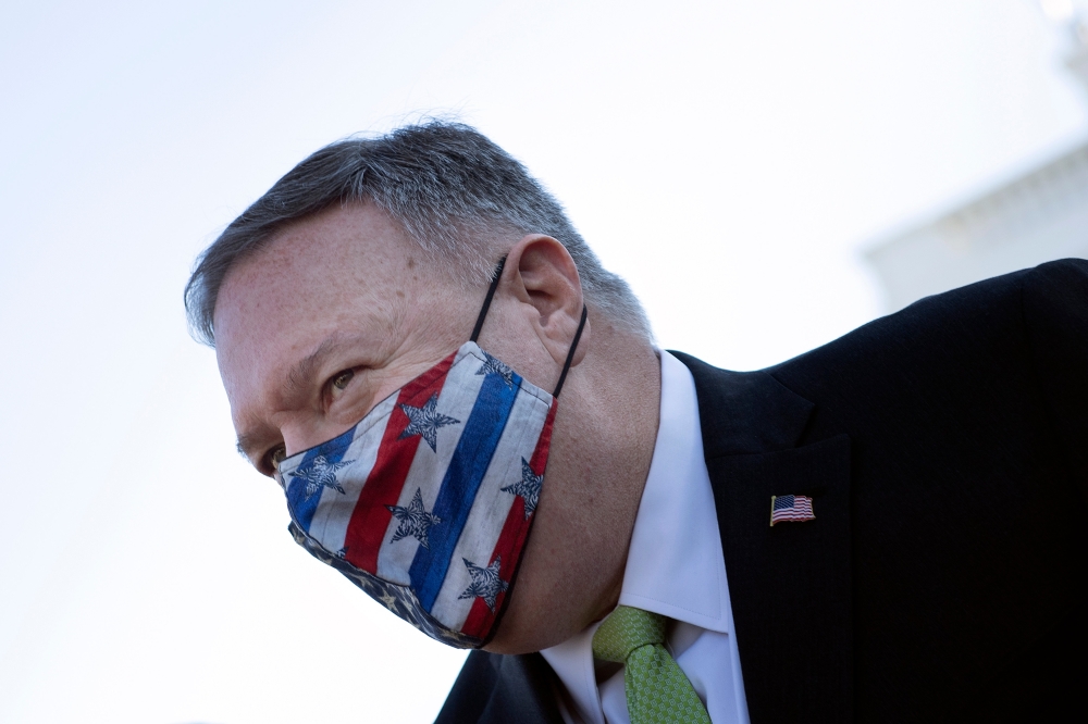 In this file photo US Secretary of State Mike Pompeo leaves the White House after visiting with family December 11, 2020, in Washington, DC. AFP / Brendan Smialowski