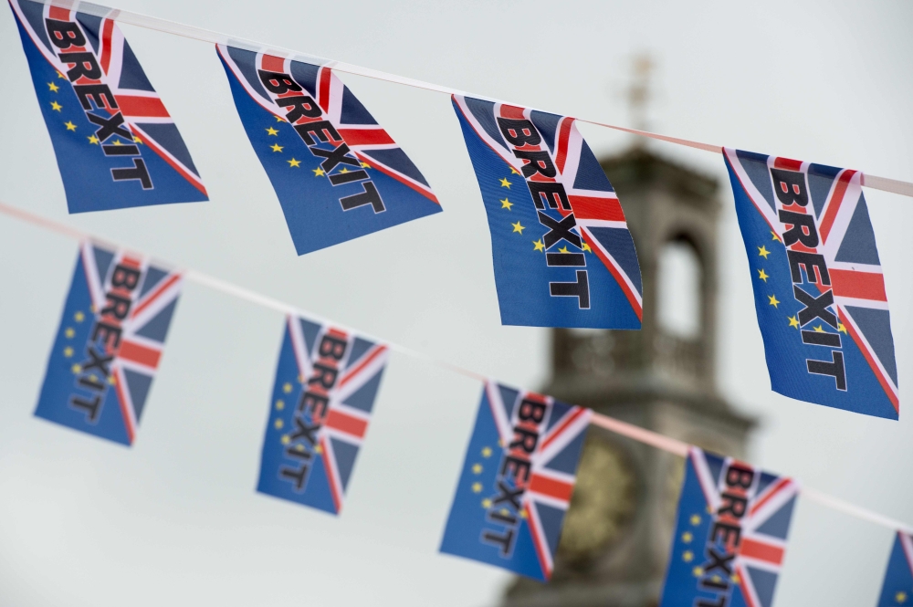 (FILES) In this file photo taken on June 13, 2016, Pro-Brexit flags fly from a fishing boat moored in Ramsgate on June 13, 2016. AFP / Chris J Ratcliffe 