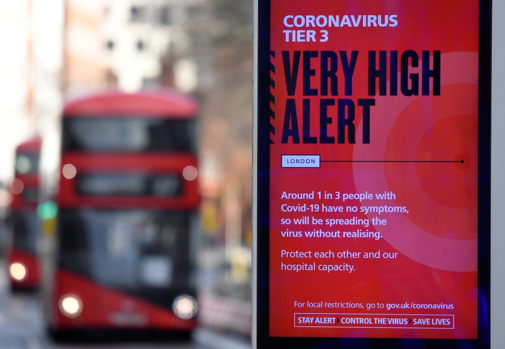 A British government health information advertisement highlighting new restrictions amid the spread of the coronavirus disease (COVID-19) is seen in London, Britain, December 19, 2020. REUTERS/Toby Melville