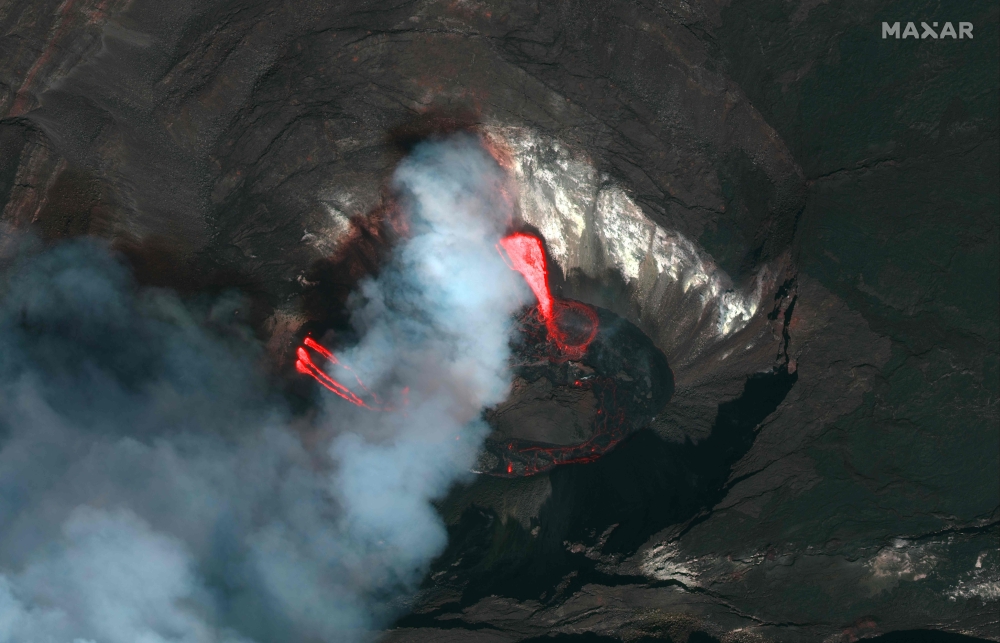This handout satellite image taken and released by Maxar on December 21, 2020 shows the Kilauea volcano on Hawaii's Big Island, which began erupting late on December 20. The Kilauea volcano on Hawaii's Big Island erupted late on December 20, authorities s