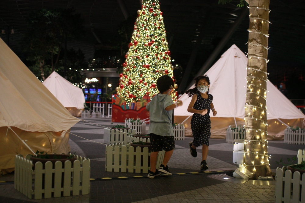 Children play a game of tag at Changi AirportÕs indoor glamping grounds after checking in, in Singapore, December 21, 2020. Picture taken December 21, 2020. REUTERS/Ying Shan Lee