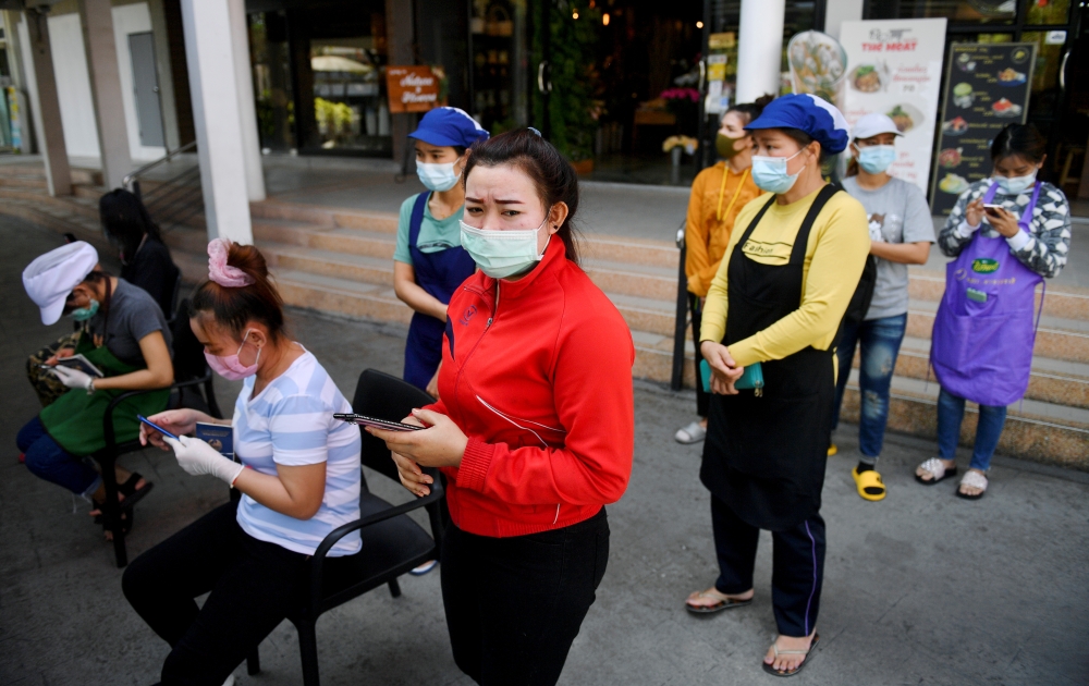 Migrant workers queue to talk with the public health authorities for a COVID-19 investigation at a fresh market, amid the coronavirus disease (COVID-19) outbreak, in Bangkok, Thailand, December 22, 2020. Reuters/Chalinee Thirasupa