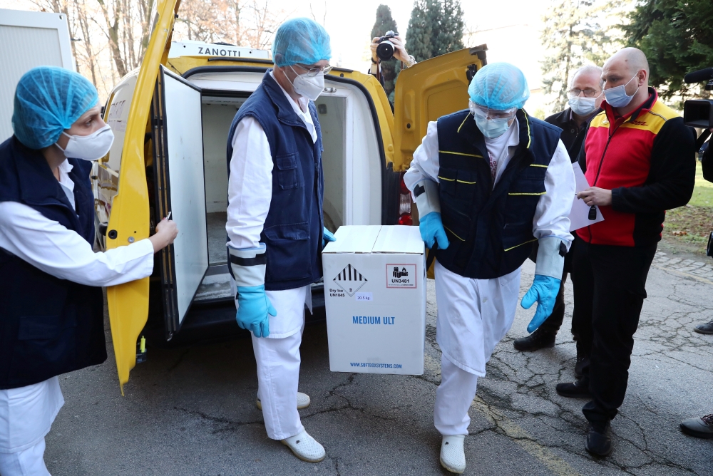 Medical workers receive the first shipment of Pfizer-BioNTech coronavirus disease (COVID-19) vaccines at The Institute of Virology, Vaccines and Sera 