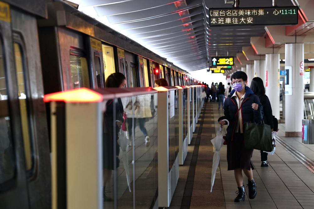 People wear protective masks to prevent the spread of the coronavirus disease (COVID-19) while riding the metro in Taipei, Taiwan, December 23, 2020. REUTERS/Ann Wang