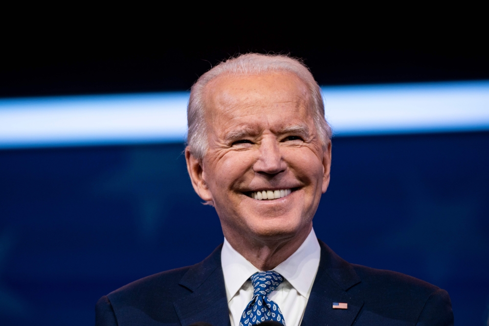FILE PHOTO: US President-Elect Joe Biden delivers remarks, before the holiday, at The Queen in Wilmington, Delaware.  AFP / Alex Edelman