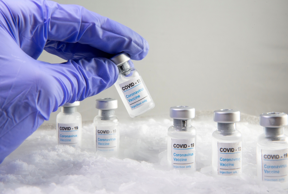 Woman holds a vial labelled 