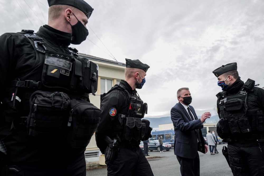 French Gendarmes speak with a man at the Gendarmerie in Ambert, central France on December 23, 2020, after three gendarmes were killed and a fourth wounded by a gunman they confronted in response to a domestic violence call in Saint-Just. AFP / Olivier Ch