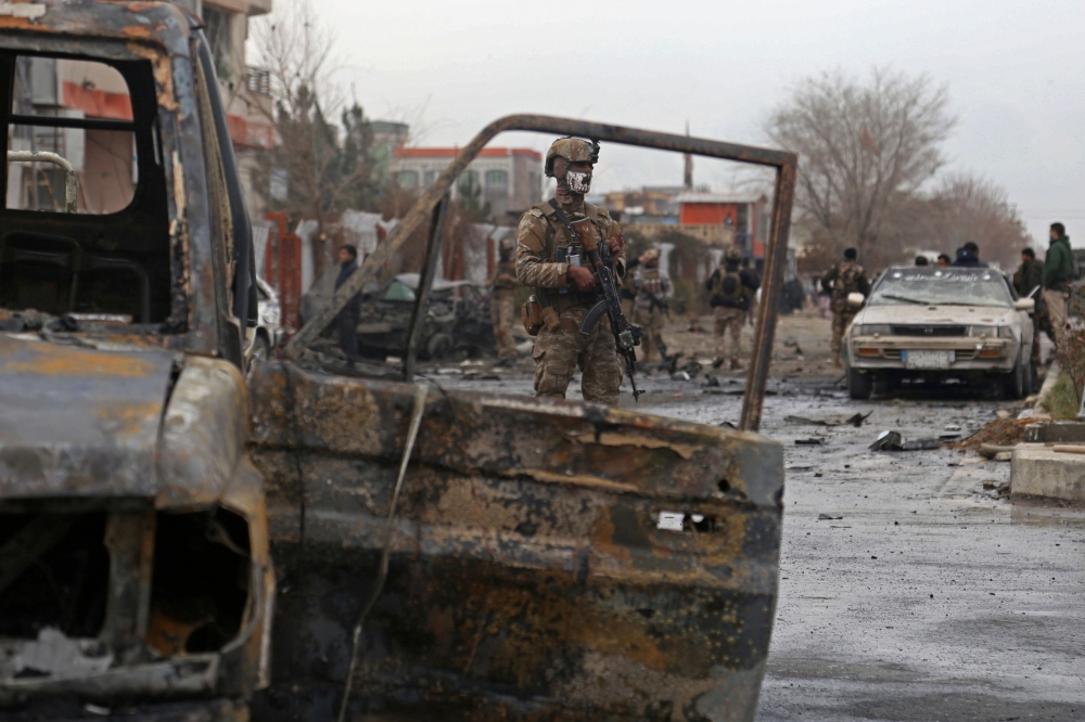 A member of Afghan security force stands guard at the site of an attack in Kabul on December 20, 2020. A car bomb targeting an Afghan lawmaker killed nine people and wounded more than a dozen in Kabul on December 20, officials said, the latest attack to r