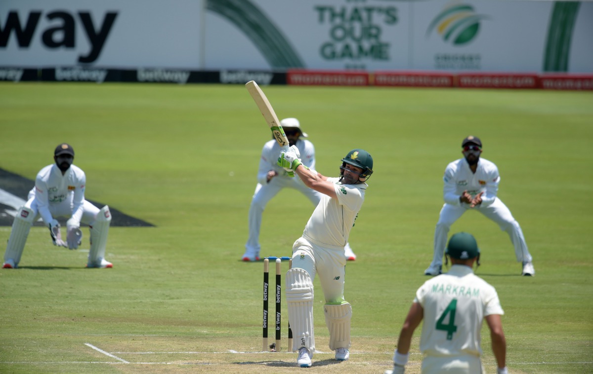 South Africa's Dean Elgar (C) plays a shot during the second day of the first Test cricket match between South Africa and Sri Lanka at SuperSport Park in Centurion on December 27, 2020. / AFP / Christiaan Kotze
