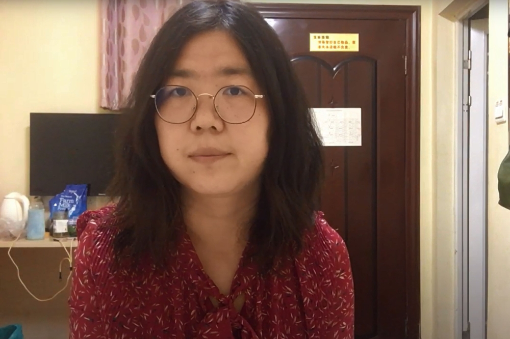 This screengrab taken on December 28, 2020 from an undated video showing former Chinese lawyer and citizen journalist Zhang Zhan as she broadcasts via YouTube, at an unconfirmed location in China. AFP / YouTube / Handout 