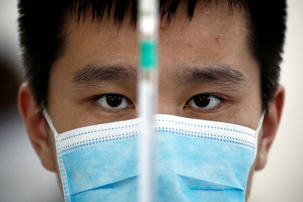 A man works in a laboratory of Chinese vaccine maker Sinovac Biotech, developing an experimental coronavirus disease (COVID-19) vaccine, during a government-organized media tour in Beijing, China, Sept. 24, 2020. Reuters/Thomas Peter/File Photo