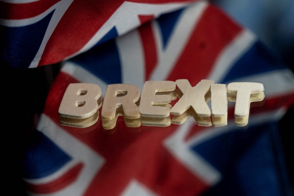 This file photograph taken on December 10, 2020, shows the flags of the United Kingdom and the European Union next to the 