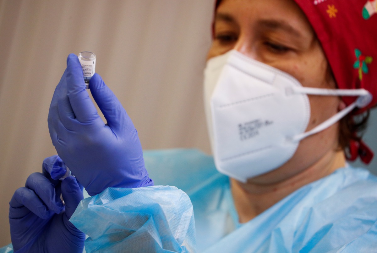 A health worker prepares an injection with a dose of the Pfizer-BioNTech COVID-19 vaccine, as the coronavirus disease (COVID-19) outbreak continues, at Balafia nursing home, in Lleida, Spain, December 27, 2020. REUTERS/Albert Gea
