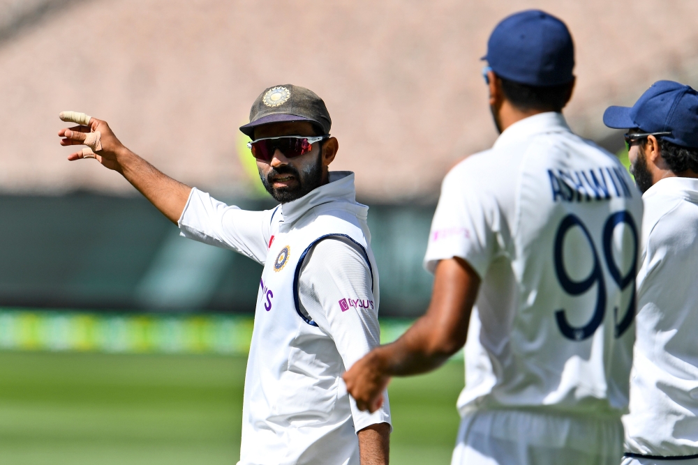 India's Ajinkya Rahane (L) directs his players on the fourth day of the second cricket Test match between Australia and India at the MCG in Melbourne on December 29, 2020. AFP / William West  