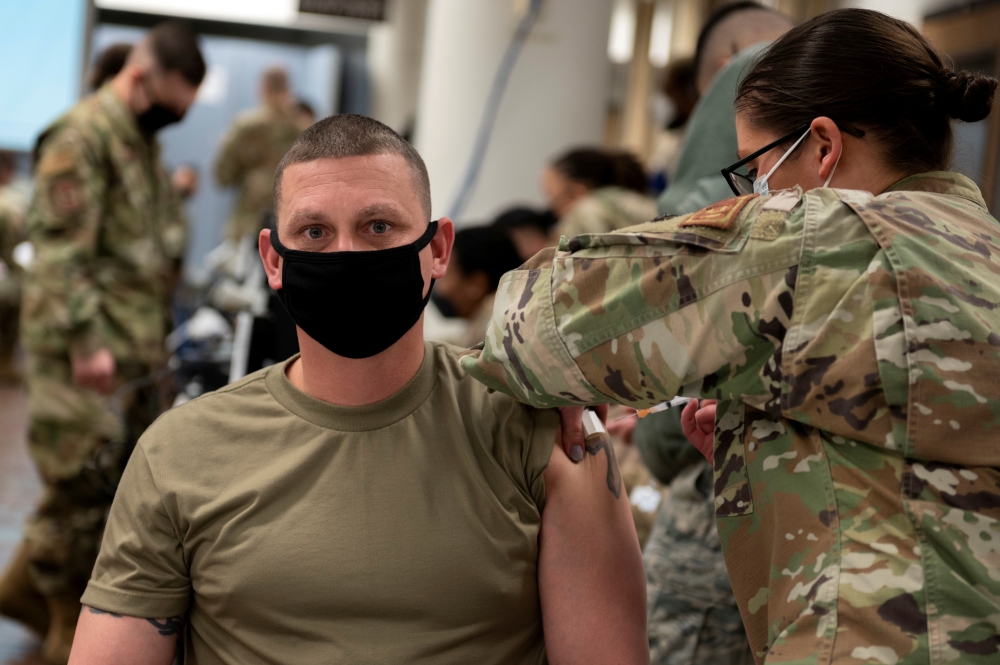 A U.S. Air Force soldier gets a coronavirus disease (COVID-19) vaccine at Osan Air Base in Pyeongtaek, South Korea, December 29, 2020. Staff Sgt. Betty R. Chevalier/U.S. Air Force/DVIDS/Handout via REUTERS