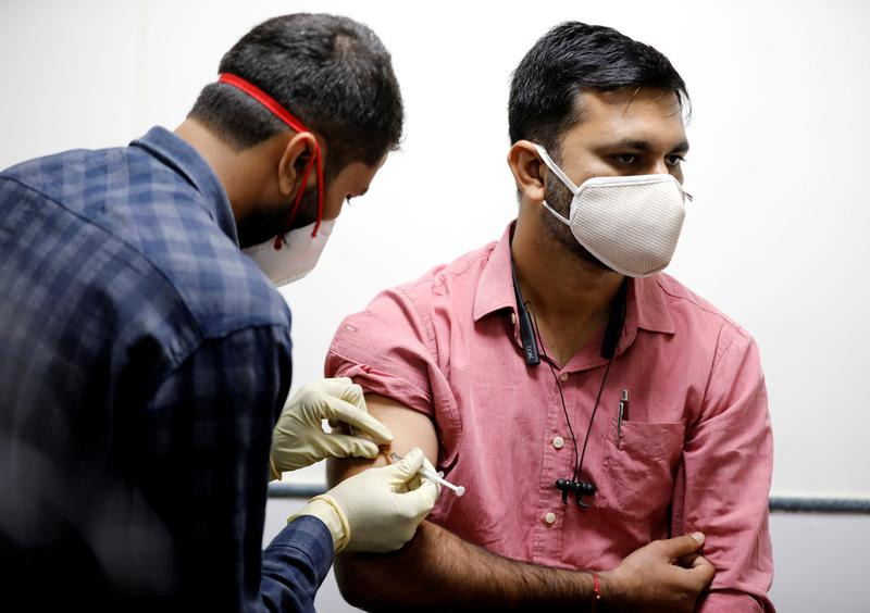 FILE PHOTO: A medic administers COVAXIN, an Indian government-backed experimental COVID-19 vaccine, to a health worker during its trials, at the Gujarat Medical Education & Research Society in Ahmedabad, India, November 26, 2020. REUTERS/Amit Dave/File Ph