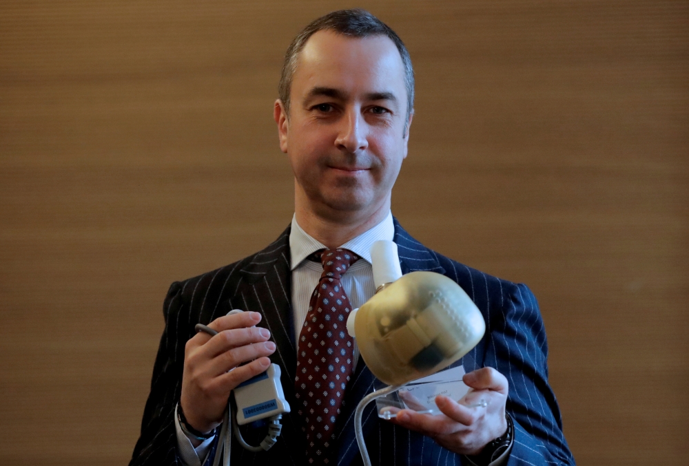 Carmat Chief Executive Officer Stephane Piat holds an artificial heart as he poses after the company's news conference in Paris, France, February 14, 2017. Reuters/Christian Hartmann/File Photo