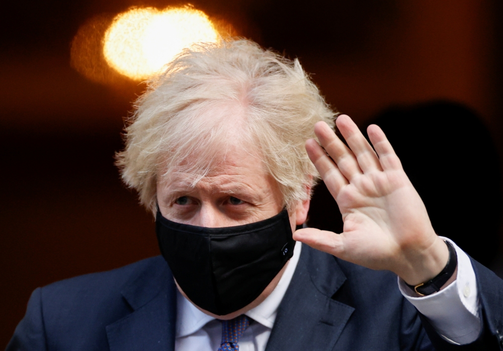 Britain's Prime Minister Boris Johnson waves as he leaves Downing Street, in London, Britain, January 6, 2021. REUTERS/John Sibley