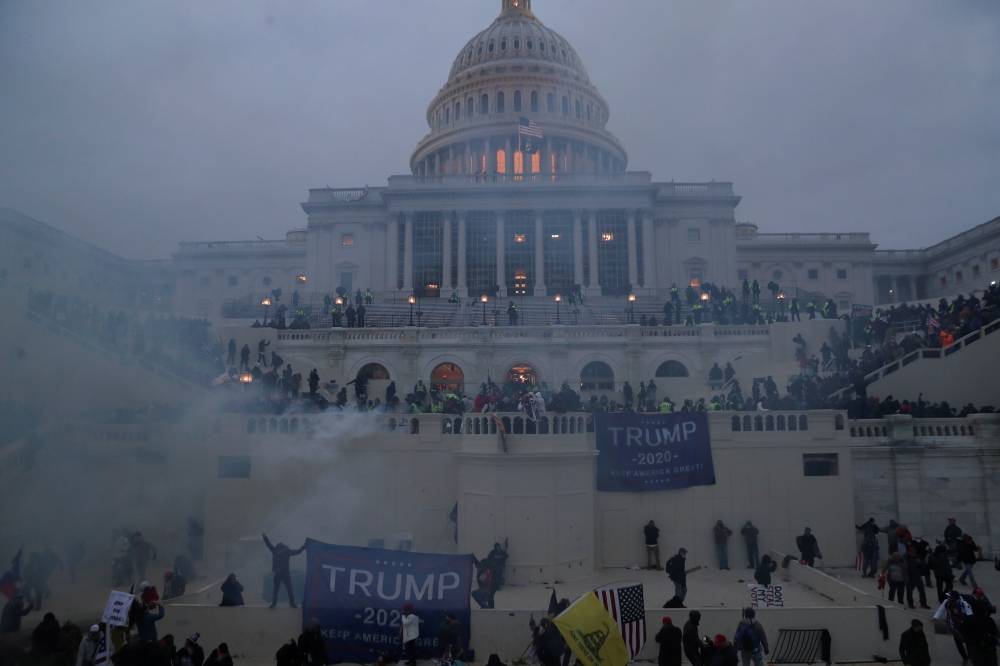 Police officers stand guard as supporters of US President Donald Trump gather in front of the US Capitol Building in Washington, US, January 6, 2021. Reuters/Leah Millis