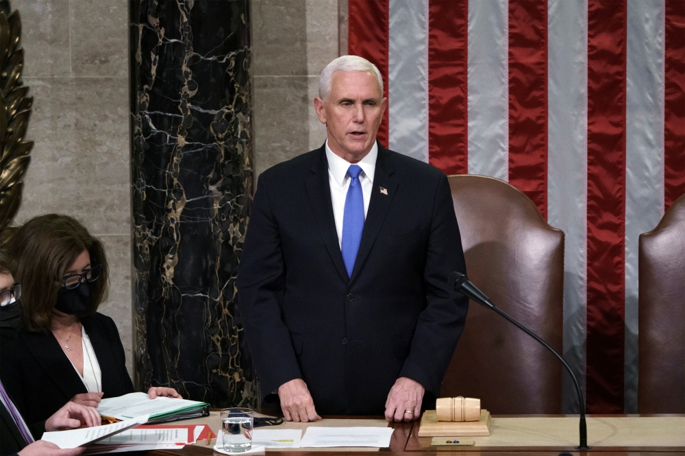 US Vice President Mike Pence reads the final certification of Electoral College votes cast in November's presidential election during a joint session of Congress after working through the night, at the Capitol in Washington, US, January 7, 2021. J Scott A