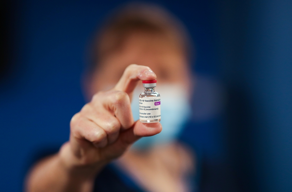 A healthcare worker holds a vial of AstraZeneca coronavirus disease (COVID-19) vaccine at the Pentland Medical Practice, in Currie, Scotland, Britain January 7, 2021. REUTERS/Russell Cheyne/Pool