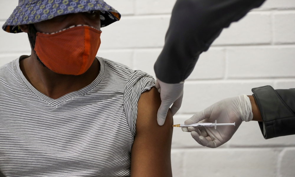 A volunteer receives an injection from a medical worker during the country's first human clinical trial for a potential vaccine against the novel coronavirus, at Baragwanath Hospital in Soweto, South Africa, June 24, 2020. Reuters/Siphiwe Sibeko/File Phot