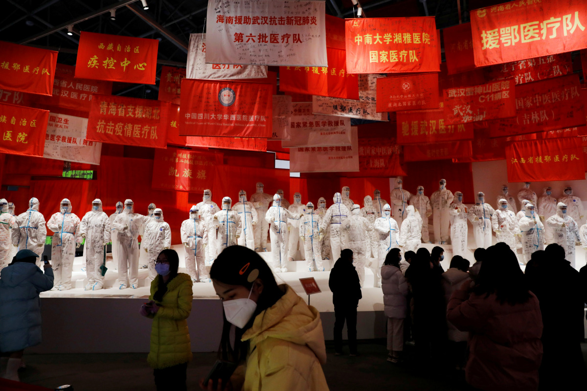 FILE PHOTO: Visitors attend an exhibition on the fight against the coronavirus disease (COVID-19) outbreak, at Wuhan Parlor Convention Center that previously served as a makeshift hospital for COVID-19 patients in Wuhan, Hubei province, China December 31,