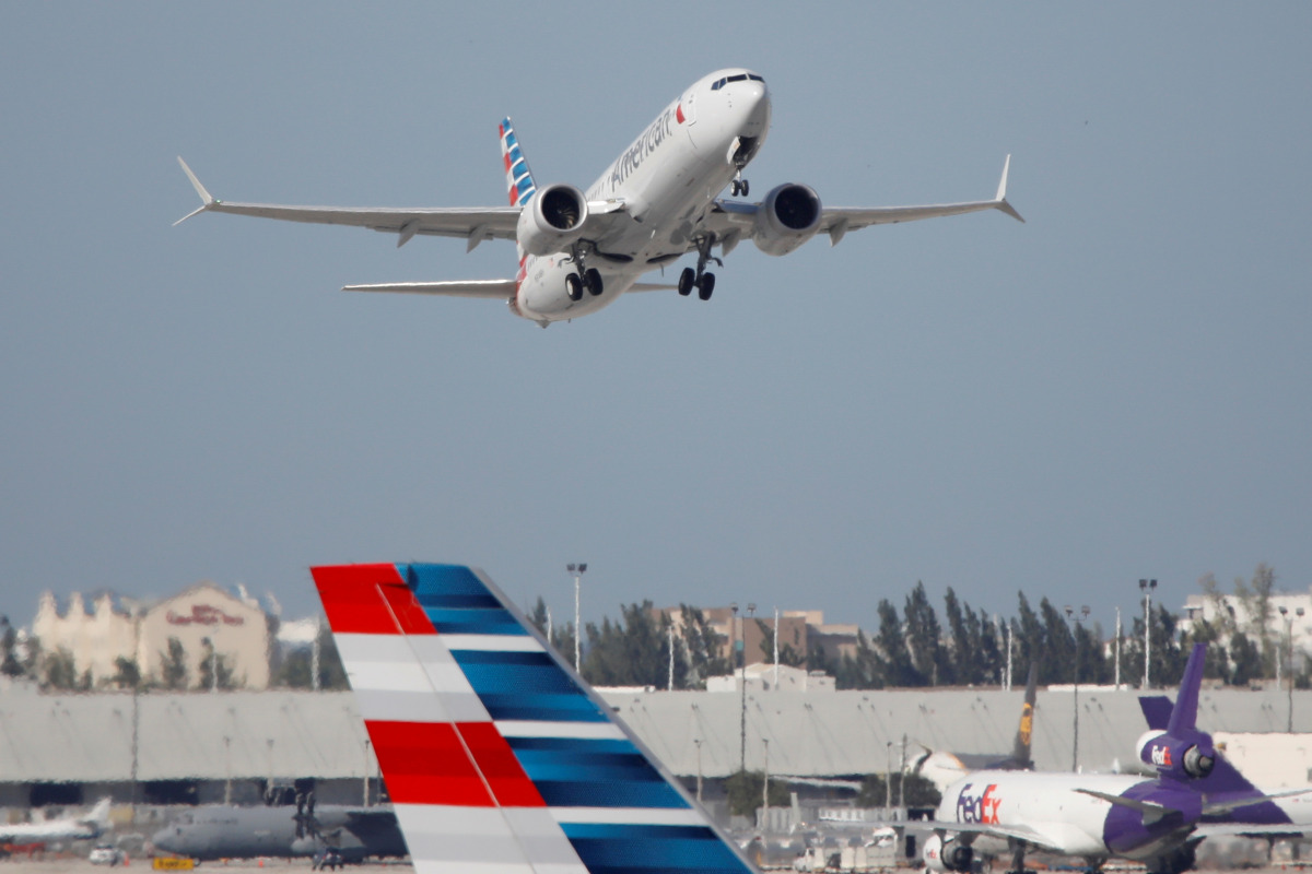 FILE PHOTO: American Airlines flight 718, the first U.S. Boeing 737 Max commercial flight since regulators lifted a 20-month grounding in November, takes off from Miami, Florida, U.S. December 29, 2020. REUTERS/Marco Bello/File Photo

