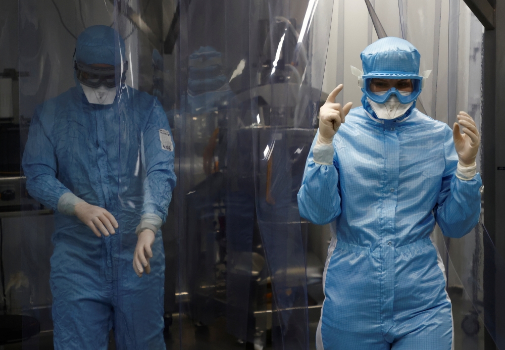Specialists are seen at Chumakov Federal Scientific Center for Research and Development of Immune-and-Biological Products, which conducts development of Russia's third vaccine against the coronavirus disease (COVID-19), in Moscow, Russia January 13, 2021.
