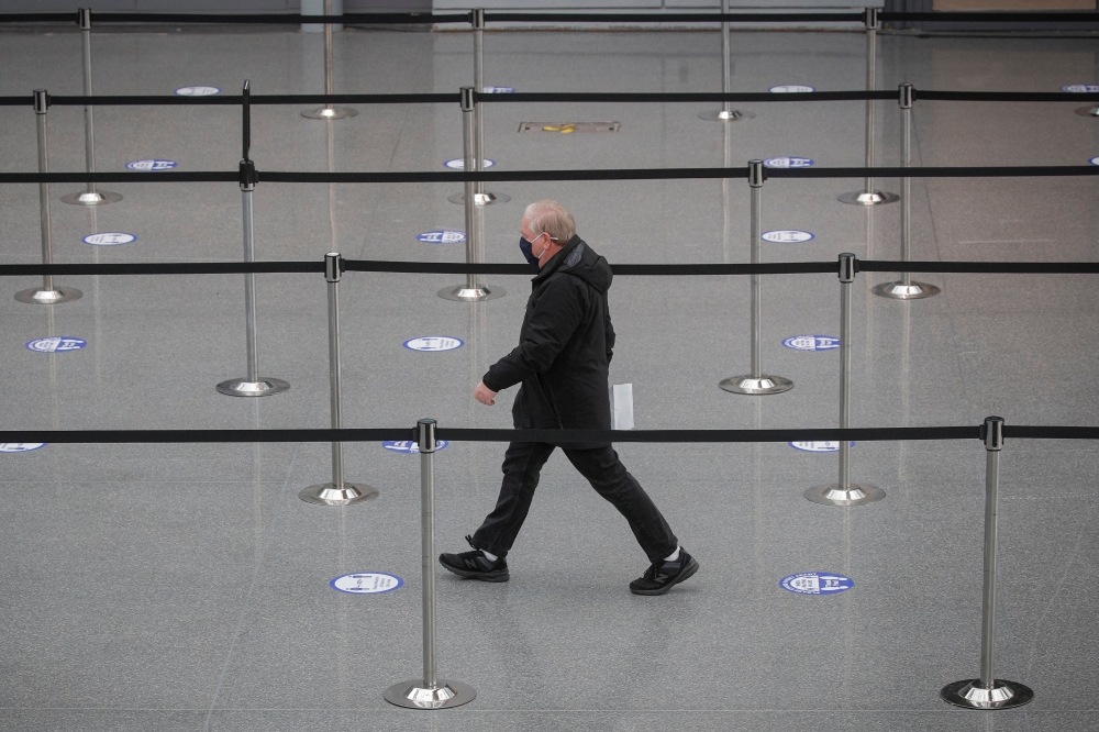 People arrive to receive doses of the coronavirus disease (COVID-19) vaccine at the New York State COVID-19 vaccination site at the Jacob K. Javits Convention Center, in New York City, U.S., January 13, 2021. REUTERS/Brendan McDermid