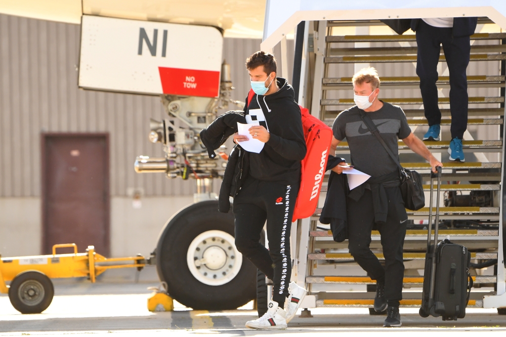 Tennis players and officials exit off flight at Melbourne Jet Base, to undergo a quarantine required of all players competing in the upcoming Australian Open, in Melbourne, Australia, January 14, 2021. AAP Image/James Ross via Reuters
