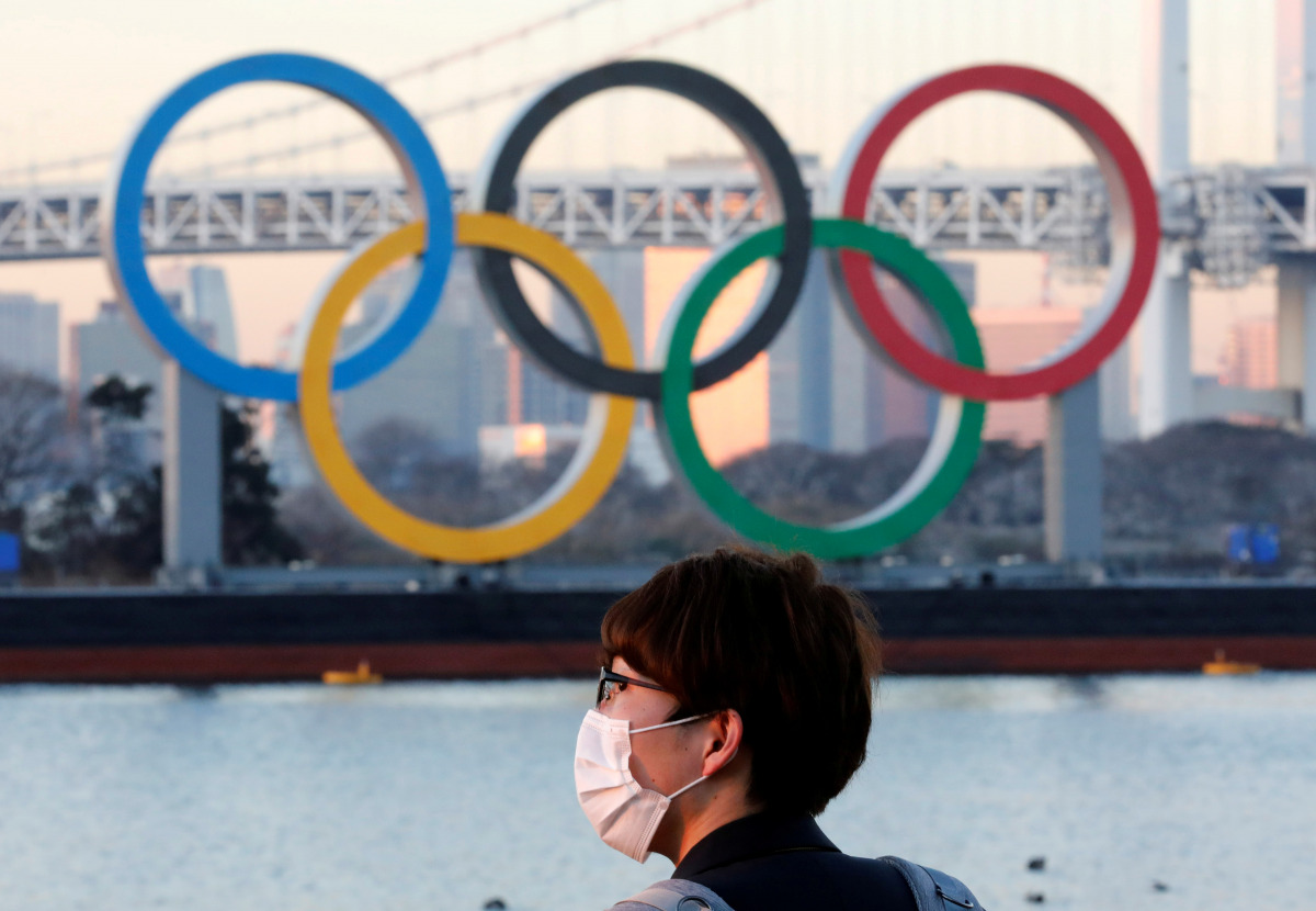 FILE PHOTO: A man wears a protective mask amid the coronavirus disease (COVID-19) outbreak in front of the giant Olympic rings in Tokyo, Japan, January 13, 2021. REUTERS/Kim Kyung-Hoon/File Photo
