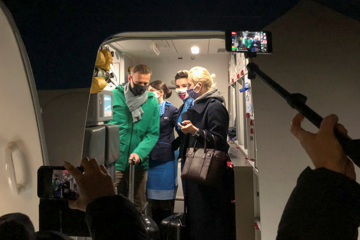 Russian opposition leader Alexei Navalny and his wife Yulia Navalnaya walk out of a plane after arriving at Sheremetyevo airport in Moscow, Russia January 17, 2021. REUTERS/Polina Ivanova
