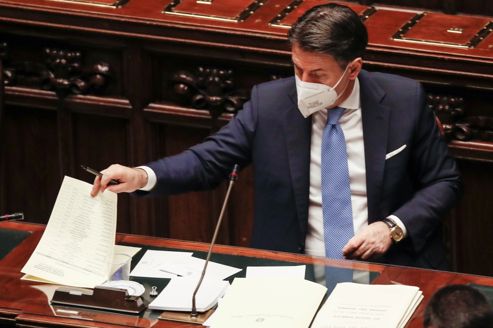 Italy's Prime Minister Giuseppe Conte looks at papers during a debate that followed his speech at the lower chamber of Parliament, in Rome, Italy, January 18, 2021. Alessandra Tarantino/Pool via REUTERS