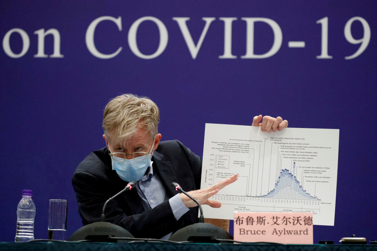 FILE PHOTO: Bruce Aylward of the World Health Organization (WHO) holds up a chart during a news conference given by the WHO-China Joint Mission on COVID-19 about its investigation of the coronavirus outbreak in Beijing, China, February 24, 2020. REUTERS/T