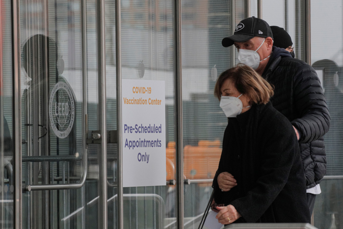 People arrive to receive a dose of the coronavirus disease vaccine at the New York State COVID-19 vaccination site at the Jacob K. Javits Convention Center, in New York City, U.S., January 15, 2021. REUTERS/Brendan McDermid
