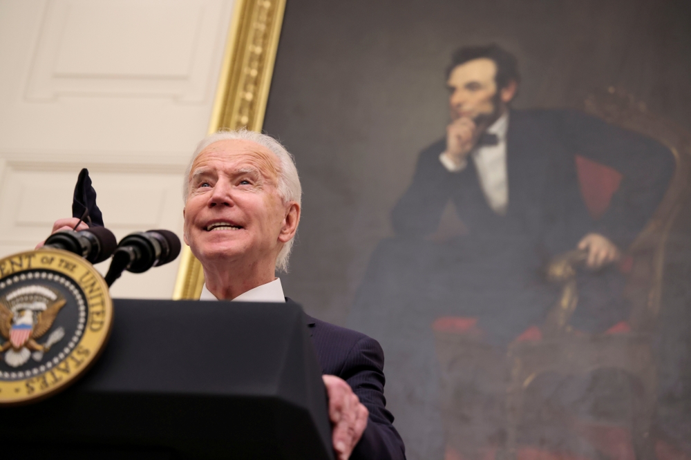 With a portrait of former President Abraham Lincoln hanging in the background, U.S. President Joe Biden speaks about his administration's plans to fight the coronavirus disease (COVID-19) pandemic during a COVID-19 response event at the White House in Was