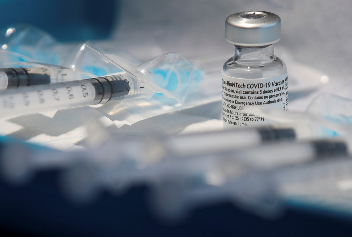 Syringes filled with a dose of the Pfizer-BioNTech coronavirus disease (COVID-19) vaccine are prepared at the CHIREC Delta Hospital in Brussels, Belgium January 21, 2021. REUTERS/Yves Herman
