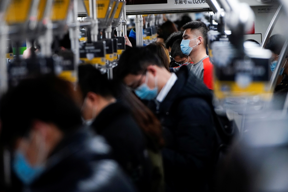 People wearing face masks are seen on a subway following an outbreak of the coronavirus disease (COVID-19) in Shanghai, China January 25, 2021. REUTERS/Aly Song