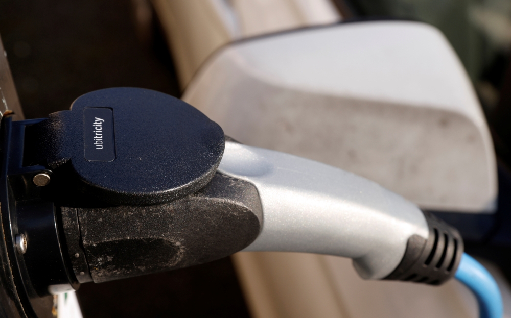 A vehicle is seen charging at an Ubitricity on-street electric vehicle charging point in London, Britain, January 25, 2021. REUTERS/John Sibley