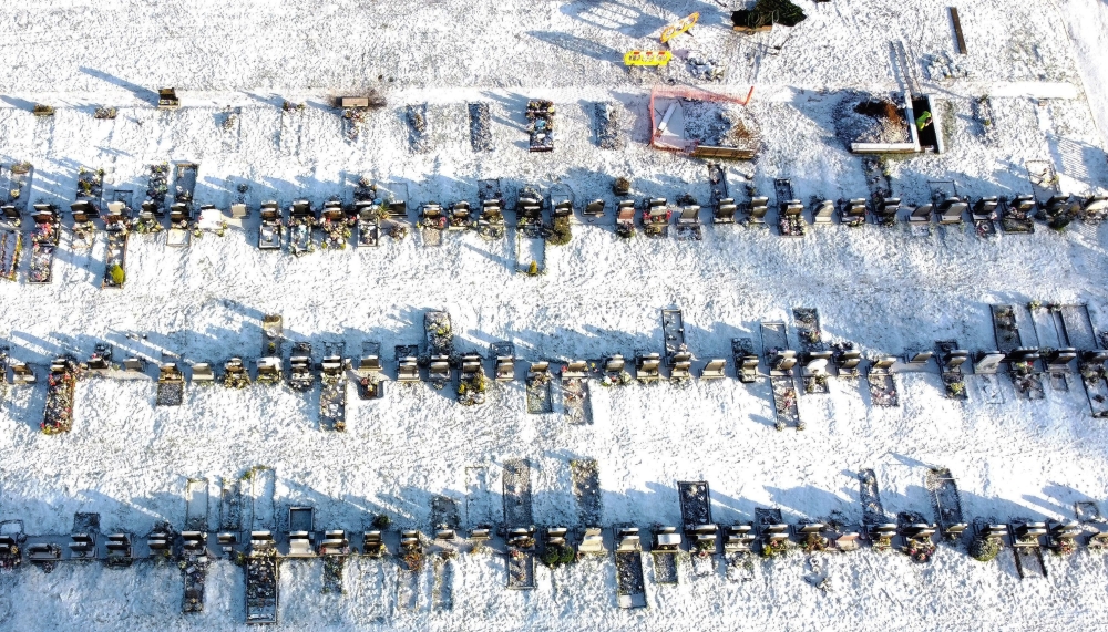 A worker digs a grave in a cemetery amid the coronavirus disease (COVID-19) outbreak in Manchester, Britain, January 25, 2021. Picture taken with a drone. REUTERS/Phil Noble
