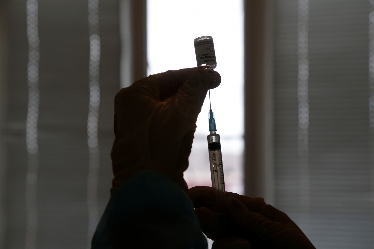A healthcare worker fills a syringe with a dose of Sputnik V (Gam-COVID-Vac) vaccine against the coronavirus disease (COVID-19) at a hospital in the village of Donskoye in Stavropol Region, Russia January 27, 2021. REUTERS/Eduard Korniyenko
