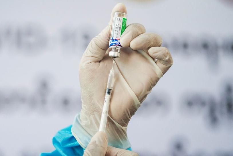 A medic inserts a syringe into a vial of AstraZeneca's COVISHIELD coronavirus disease (COVID-19) vaccine in Yangon, Myanmar, after the country received 1.5 million doses of the vaccine manufactured by the Serum Institute of India, January 27, 2021. REUTER