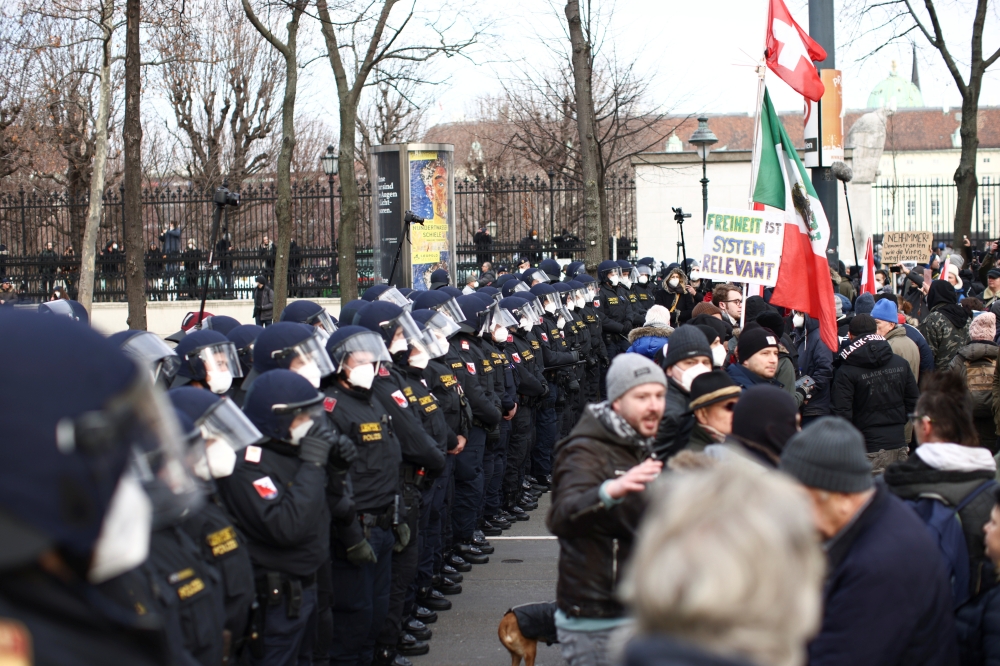 Police officers line up as people gather during a demonstration against the coronavirus disease (COVID-19) measures and their economic consequences in Vienna, Austria, January 31, 2021. REUTERS/Lisi Niesner
