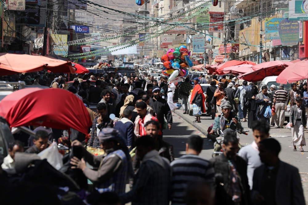 People walk at a street market in Sanaa, Yemen February 5, 2021. Reuters/Khaled Abdullah

