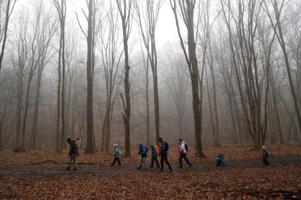 Tibor Miklosi and his family hike on National Blue Trail along the Pilis Mountains, during the coronavirus disease (COVID-19) pandemic, near Pilisszentlaszlo, Hungary, February 6, 2021. Picture taken February 6, 2021. REUTERS/Bernadett Szabo