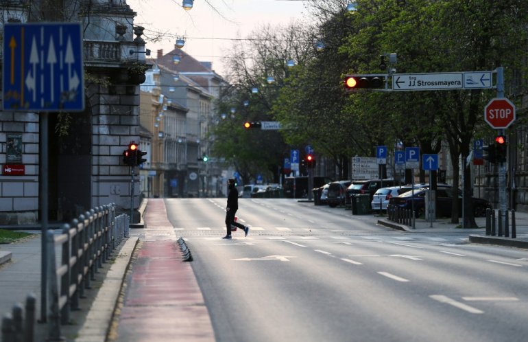 FILE PHOTO: A man crossing a street as Croatia is stepping up measures to fight the coronavirus disease (COVID-19) outbreak, in Zagreb, Croatia March 21, 2020. REUTERS/Antonio Bronic
