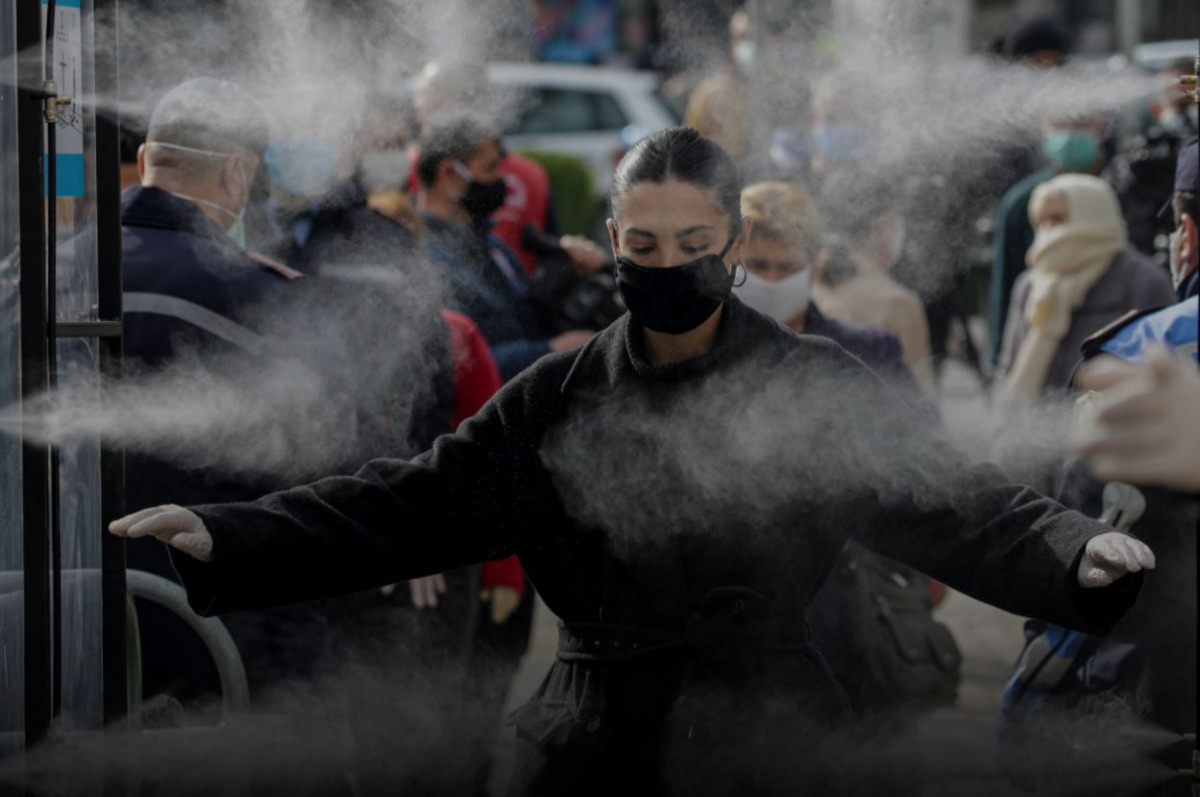 FILE PHOTO. People are disinfected before entering a market, as Albanian authorities take measures to stop the spread of the coronavirus disease (COVID-19), in Tirana, Albania April 6, 2020. REUTERS/Florion Goga
