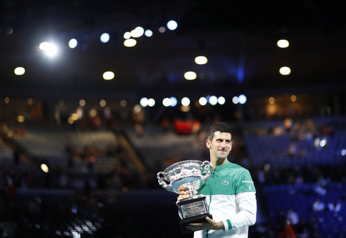 Tennis - Australian Open - Men's Singles Final - Melbourne Park, Melbourne, Australia, February 21, 2021 Serbia's Novak Djokovic celebrates with the trophy after winning his final match against Russia's Daniil Medvedev REUTERS/Asanka Brendon Ratnayake
