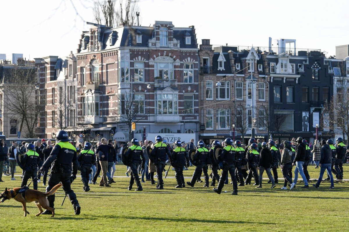 FILE PHOTO: Police officers are seen, as people protest against the coronavirus disease (COVID-19) restrictions in Amsterdam, Netherlands, February 21, 2021. REUTERS/Piroschka van de Wouw/File Photo
